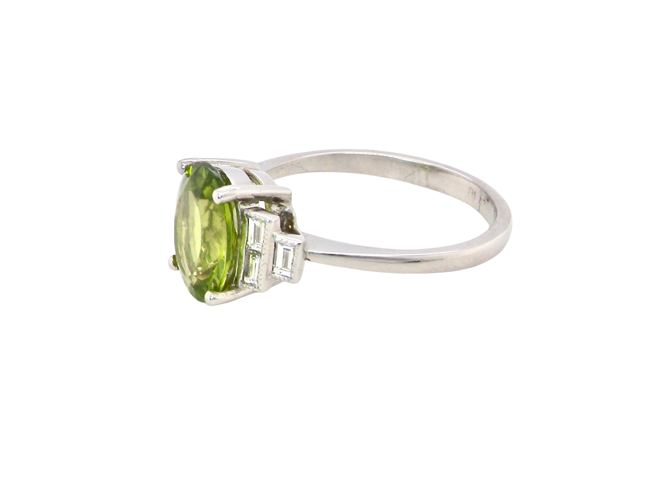 side A fine gem set ring featuring a vibrant lime-green oval faceted peridot,