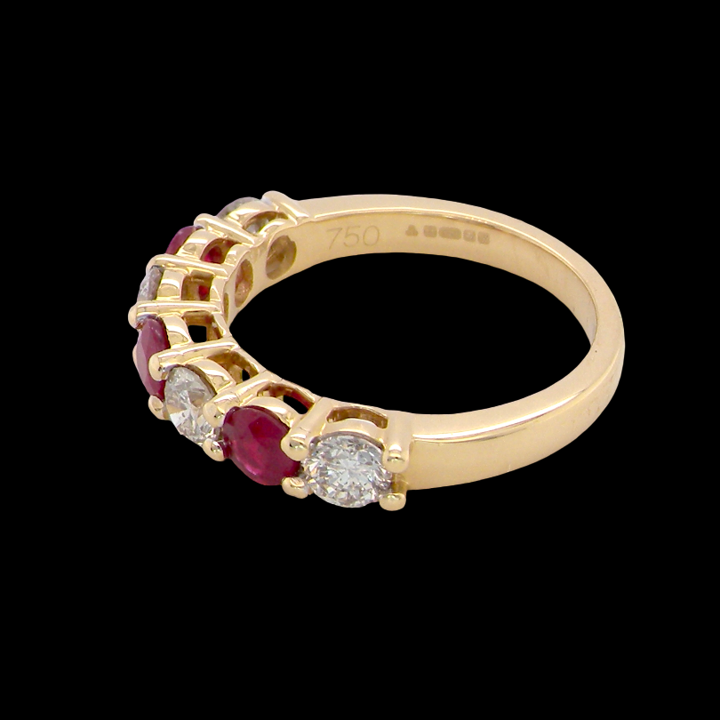side A fine half hoop ring. 18 carat gold set with three rubies, each 3.8mm (est 0.20 carats, total 0.67 carats) and four brilliant cut white diamonds, each 3.8mm (total 0.85 carats) 