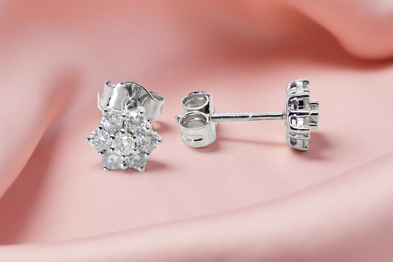 side A fine pair of 9 carat white gold diamond stud earrings. 