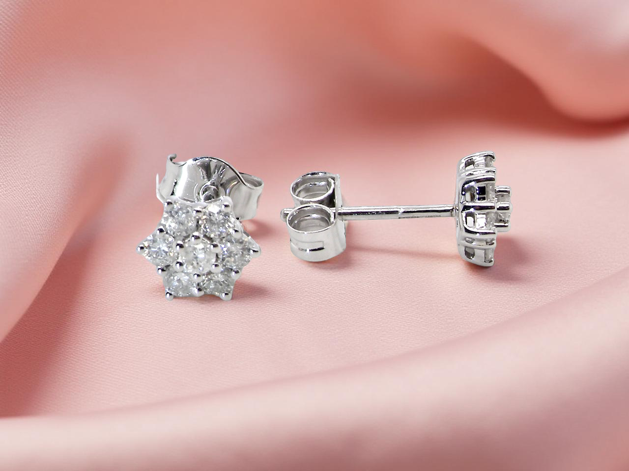 side A fine pair of 9 carat white gold diamond stud earrings. 