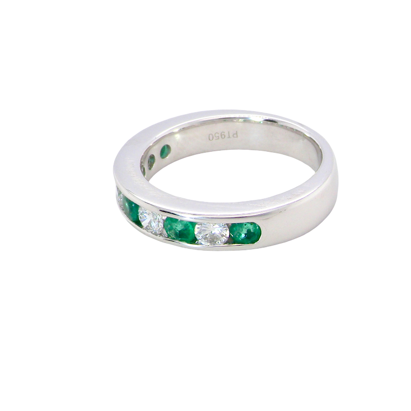 side A fine platinum half hoop eternity ring. This is a new ring*. Channel set gem stones, five bright green emeralds 2.6mm each (0.54 carats total)