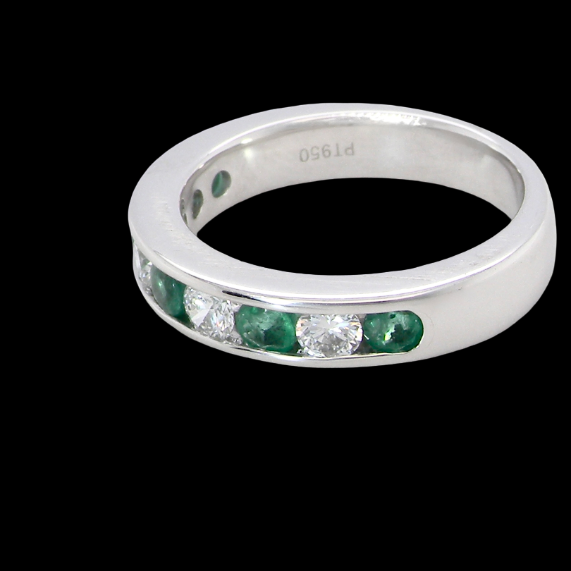 side A fine platinum half hoop eternity ring. This is a new ring*. Channel set gem stones, five bright green emeralds 2.6mm each (0.54 carats total)