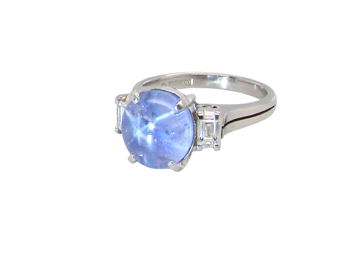 side A fine platinum* ring. Features a lovely sky blue sapphire with 'star sapphire ' chatoyancy , measures 10x9mm, (est 4 carats) held by four claws, cabouchon cut