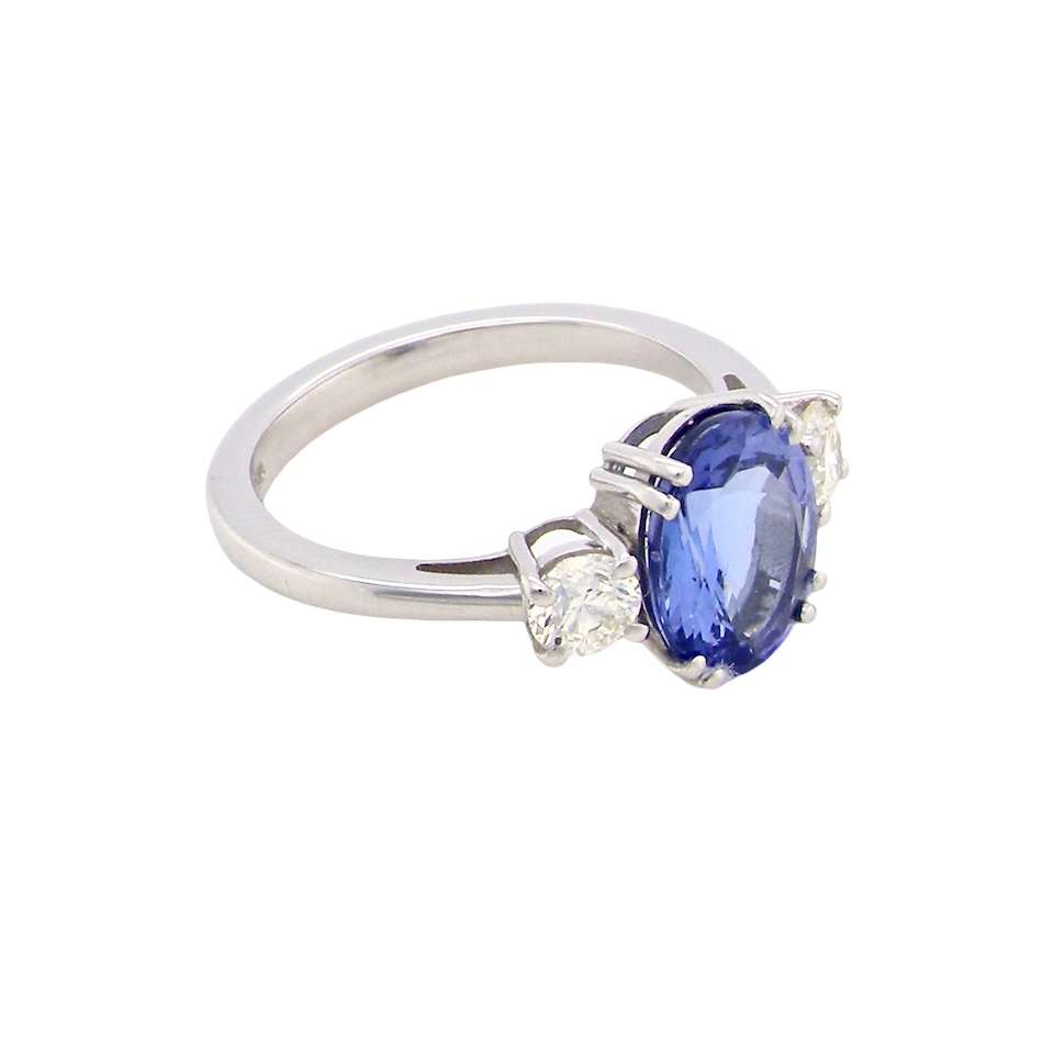 side A fine three stone trilogy ring. The centre stone a 4A tanzanite gem stone, measures 10x8mm (est 3 carats) 