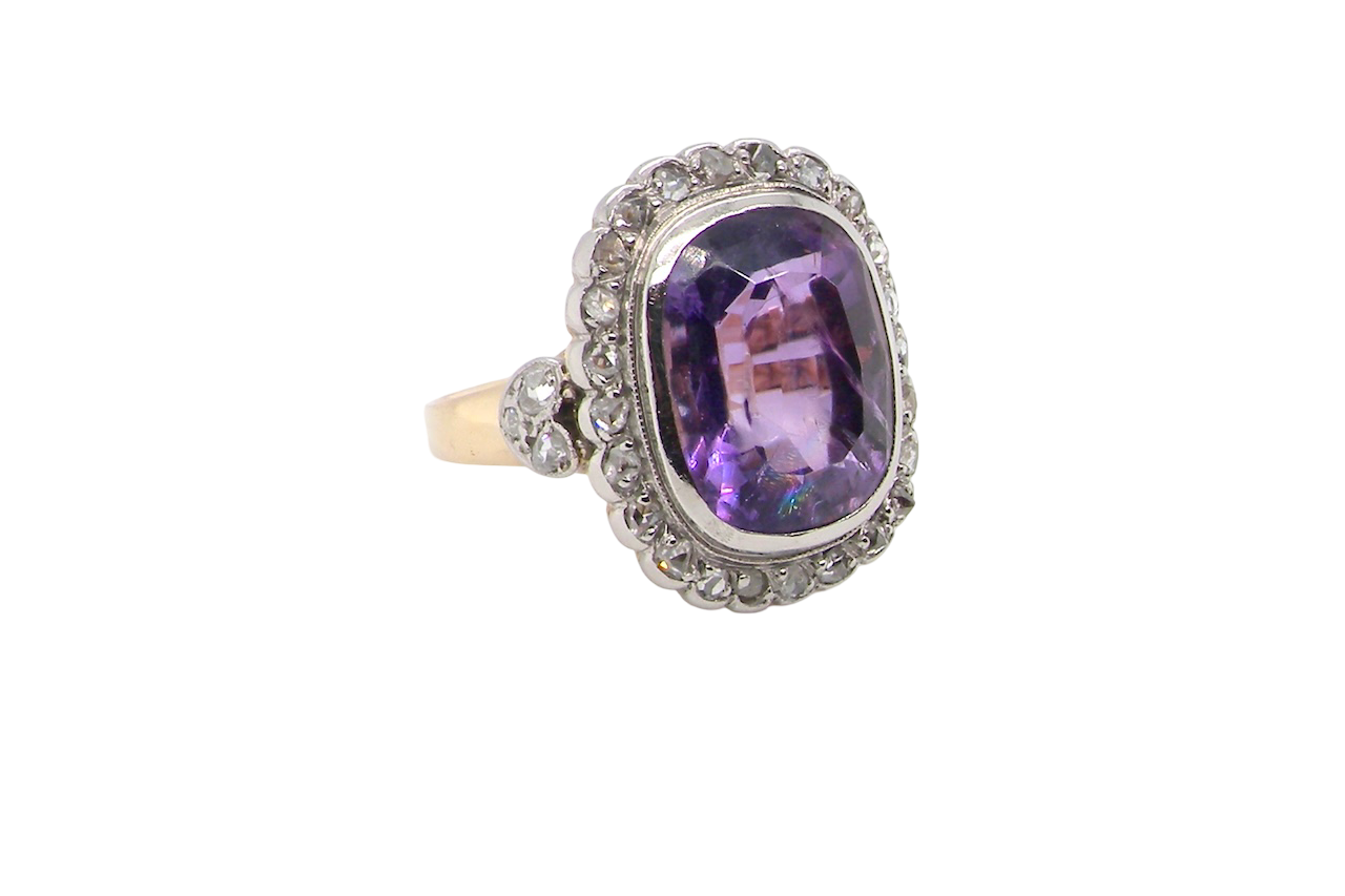 side A fine vintage ring. Features to the centre a large cushion shaped amethyst, 13x10mm, rim setting.