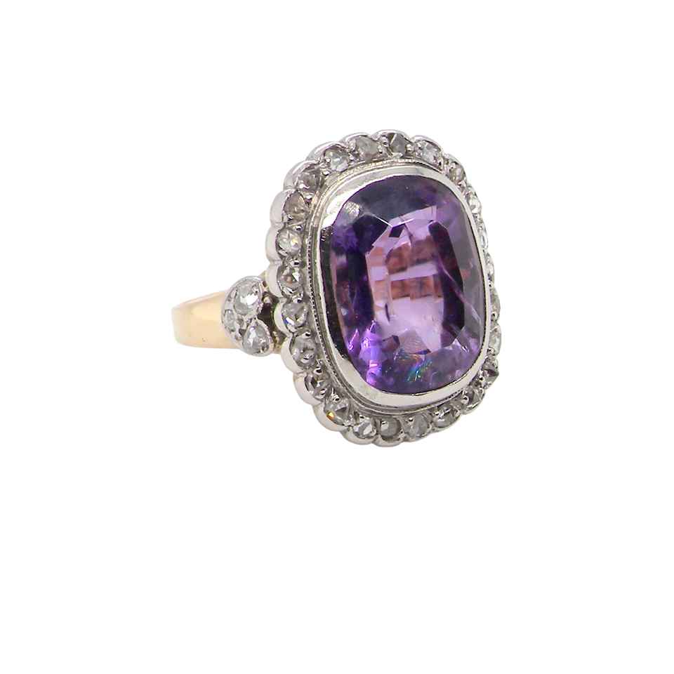 side A fine vintage ring. Features to the centre a large cushion shaped amethyst, 13x10mm, rim setting.