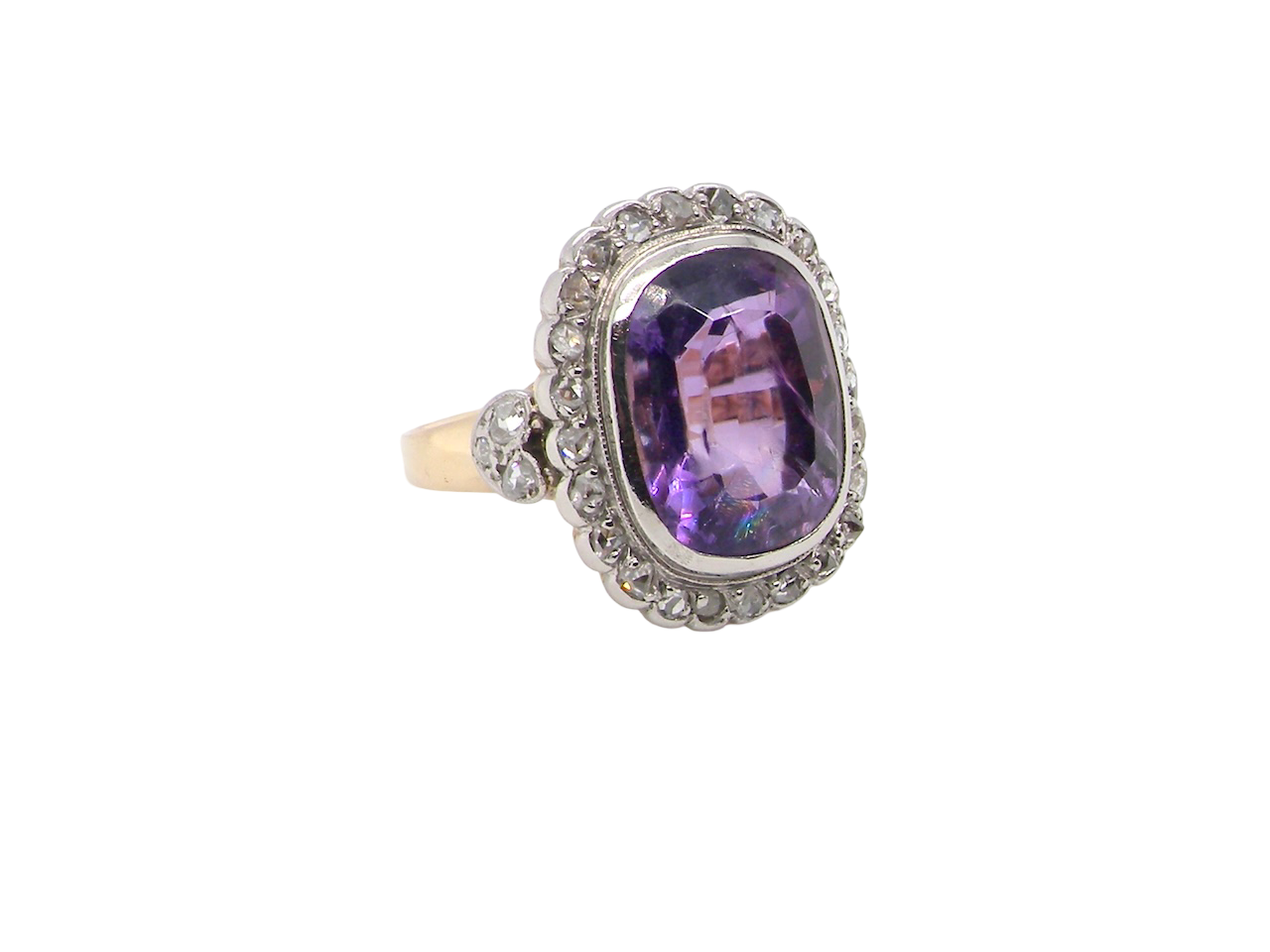 side A fine vintage ring. Features to the centre a large cushion shaped amethyst, 13x10mm, rim setting.