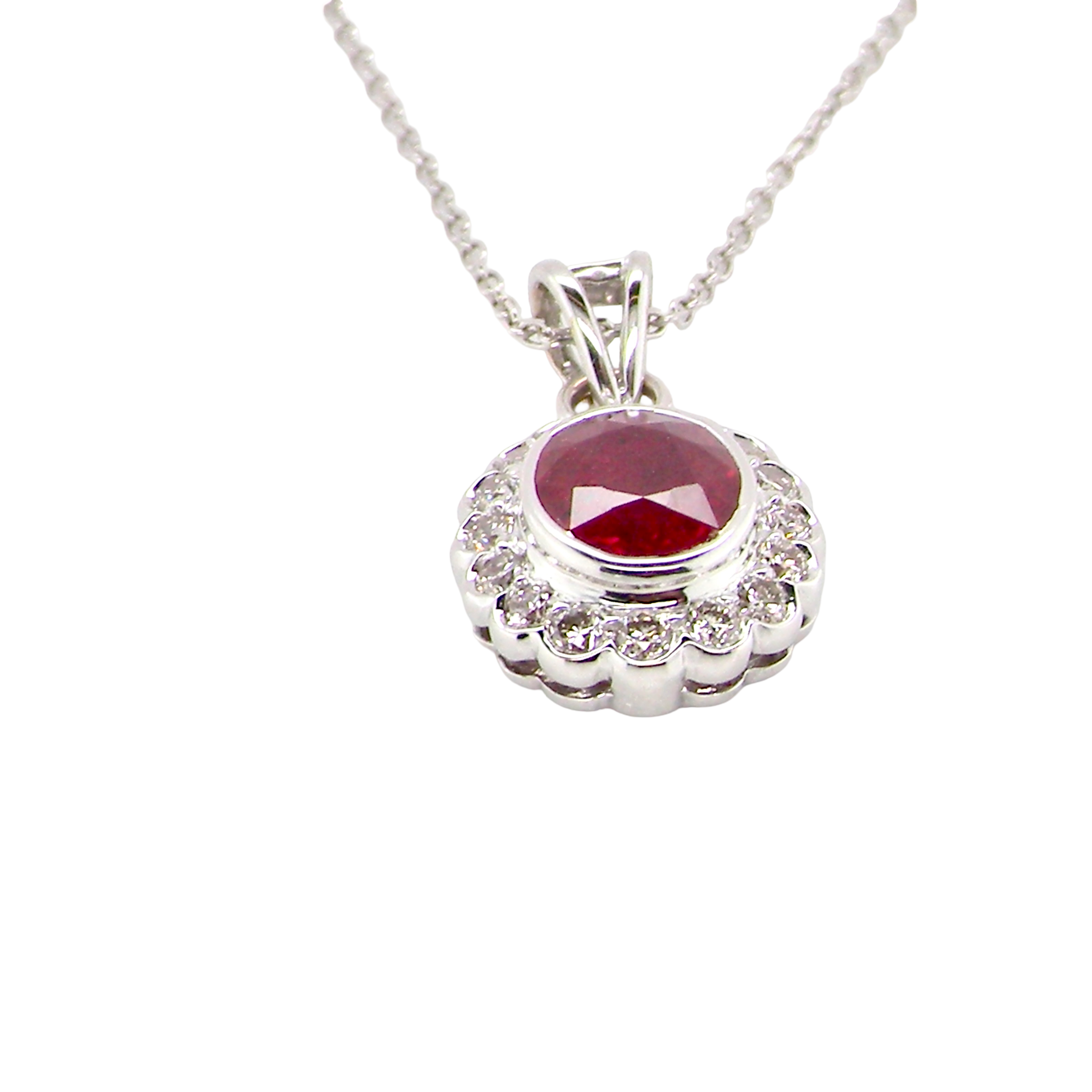 side A fine white gold pendant that features to the centre an oval facet cut ruby, 8x6mm (est 1.25 carats) good deep red colour.