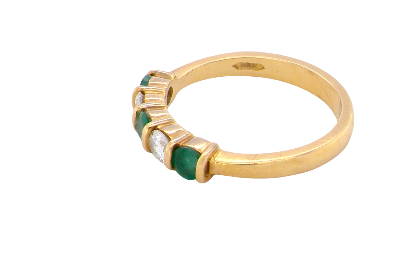 side A five stone ring set with three emeralds, each 3mm diameter.
Between each two brilliant cut white diamonds, each 3.4mm (0.15 carats each est), colour i-j, clarity Si.