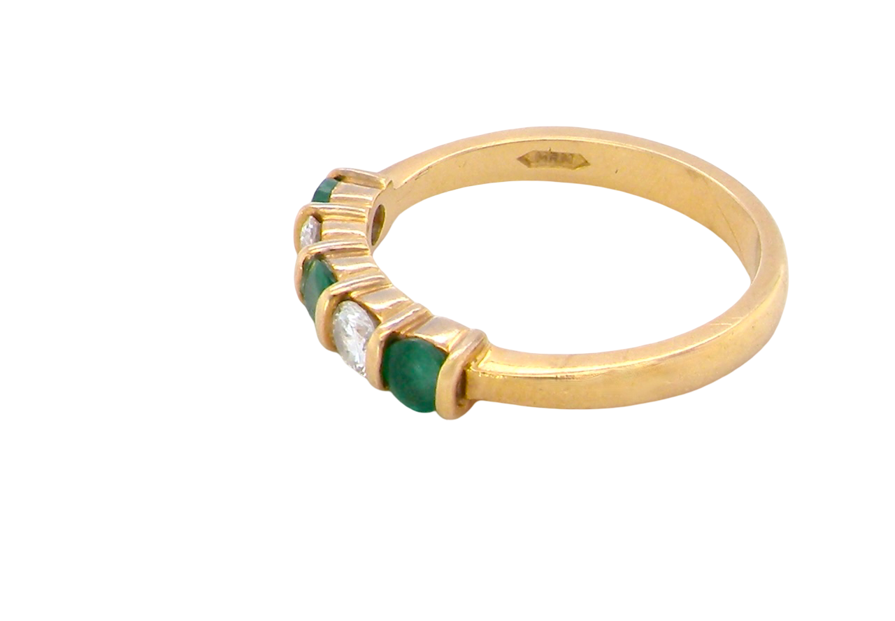 side A five stone ring set with three emeralds, each 3mm diameter.
Between each two brilliant cut white diamonds, each 3.4mm (0.15 carats each est), colour i-j, clarity Si.