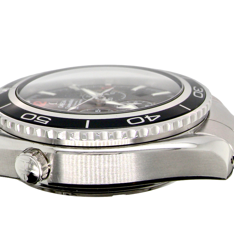 Close-up side view of a stainless steel wristwatch with a black bezel, silver case, and metal link bracelet on a white background.