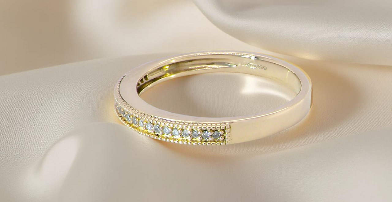 side A half-hoop eternity ring set with approximately twenty-four white diamonds