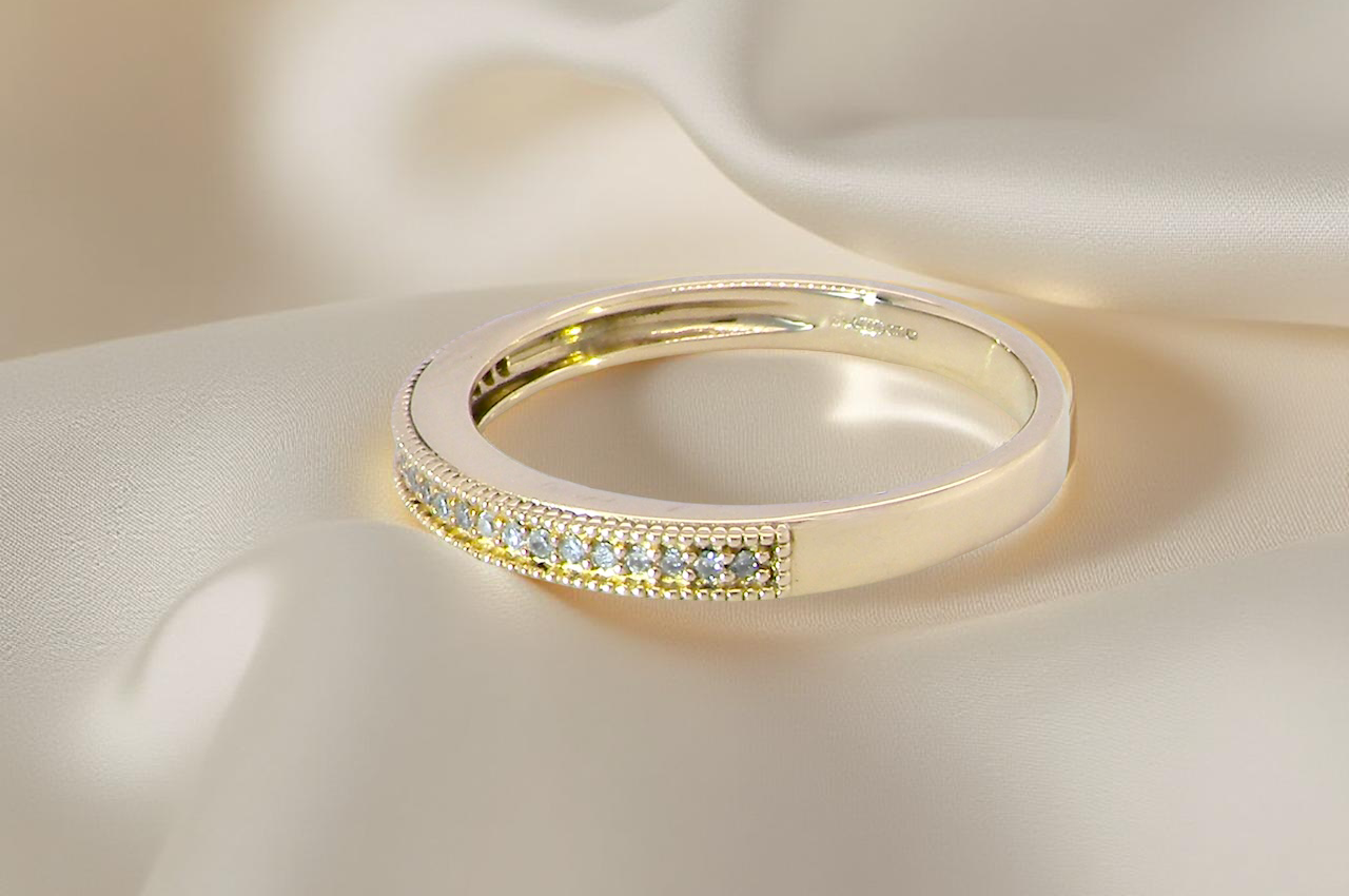 side A half-hoop eternity ring set with approximately twenty-four white diamonds