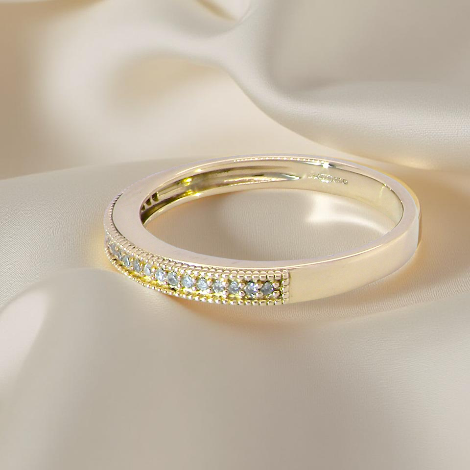 side A half-hoop eternity ring set with approximately twenty-four white diamonds