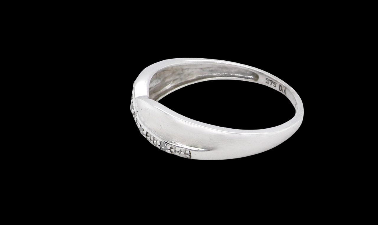 side A half hoop 9 carat white gold eternity ring. Set with five small white diamonds, each 1.3mm (total 0.05 carats)
