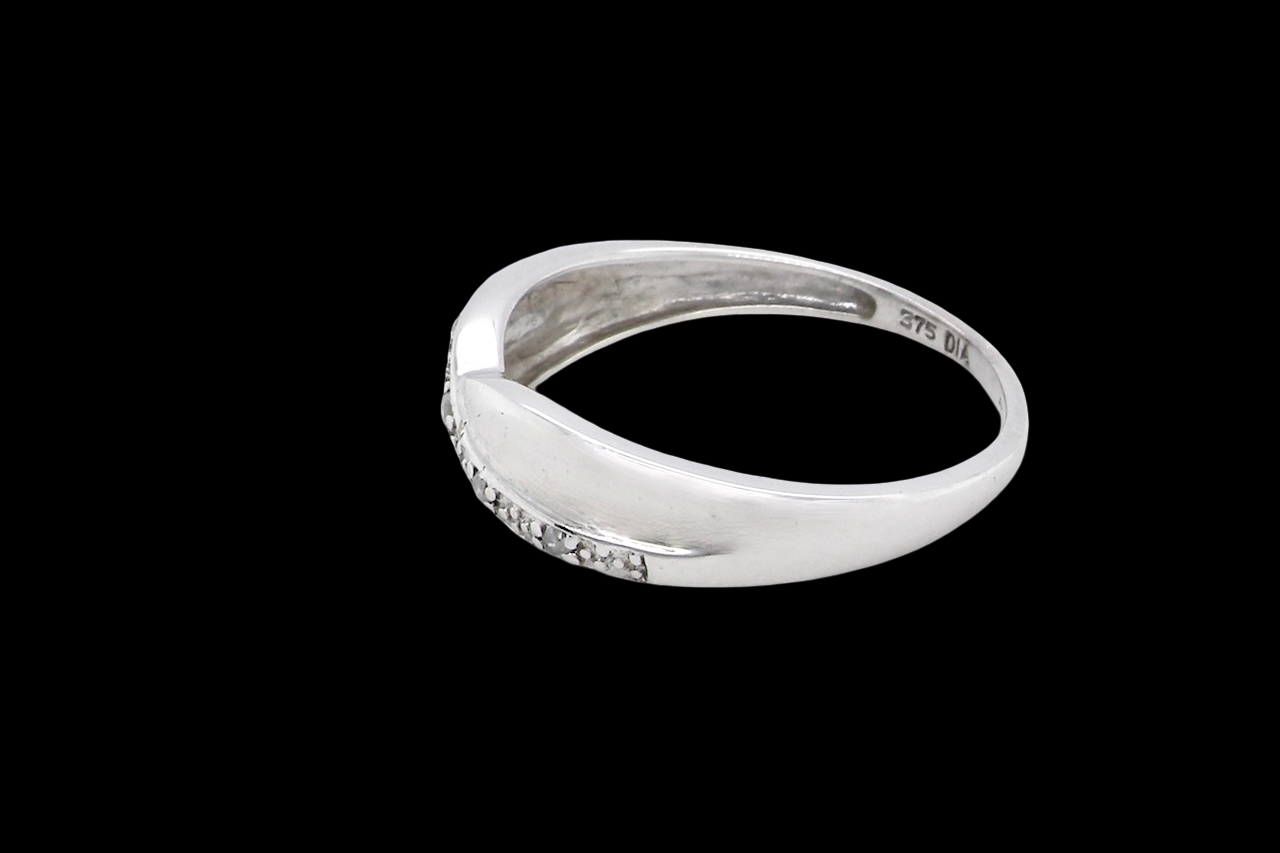 side A half hoop 9 carat white gold eternity ring. Set with five small white diamonds, each 1.3mm (total 0.05 carats)