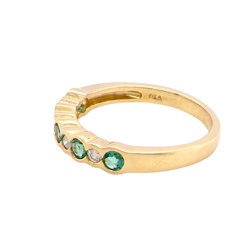 side A half hoop eternity ring. Set with five round emeralds, each 3mm (0.10 carats) and set with an alternate brilliant cut white diamond, 2.4mm each (total 0.20 carats)