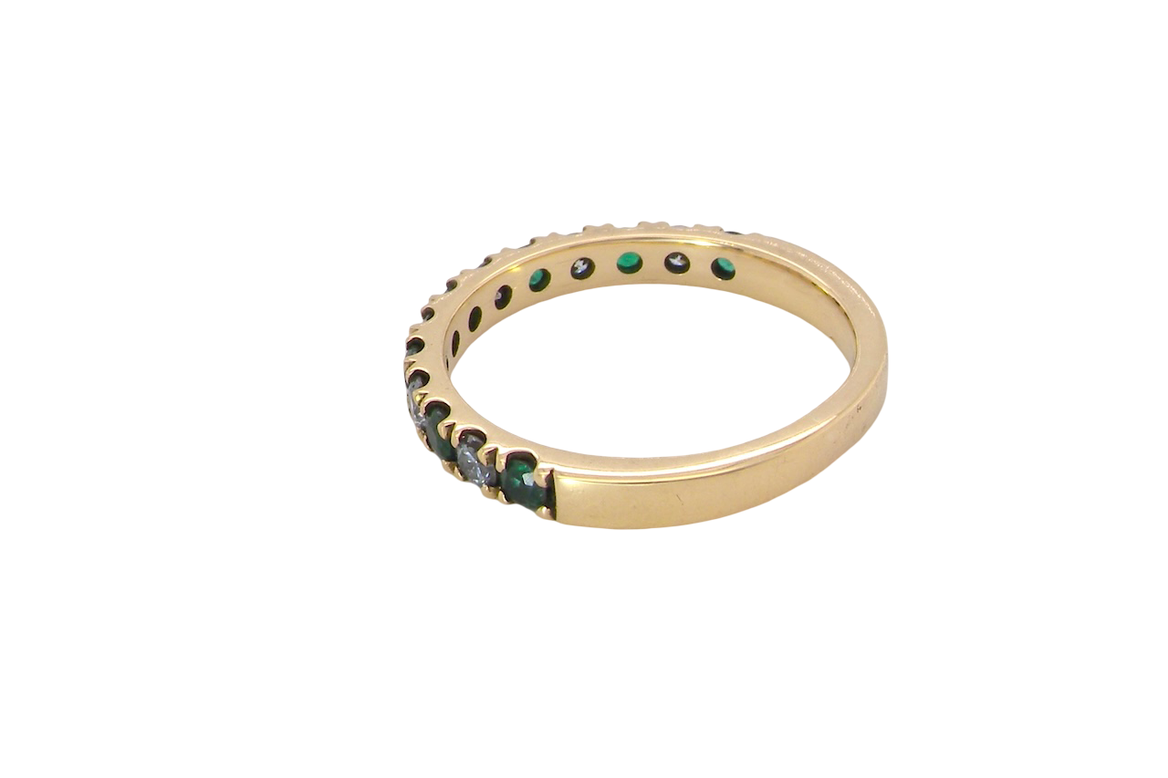 side A half hoop eternity ring. Set with seven emeralds,