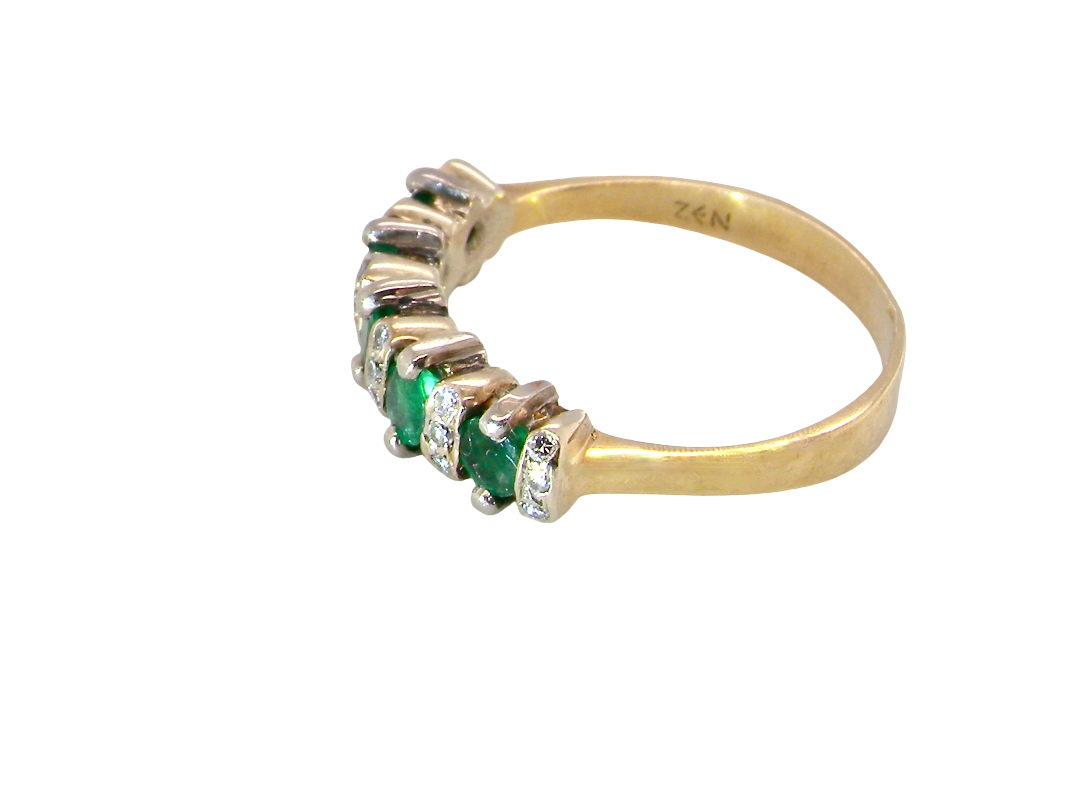 side A half hoop ring, stamped 750 (testing as 18 carat gold)
Set with alternate gemstones, five bright green emeralds