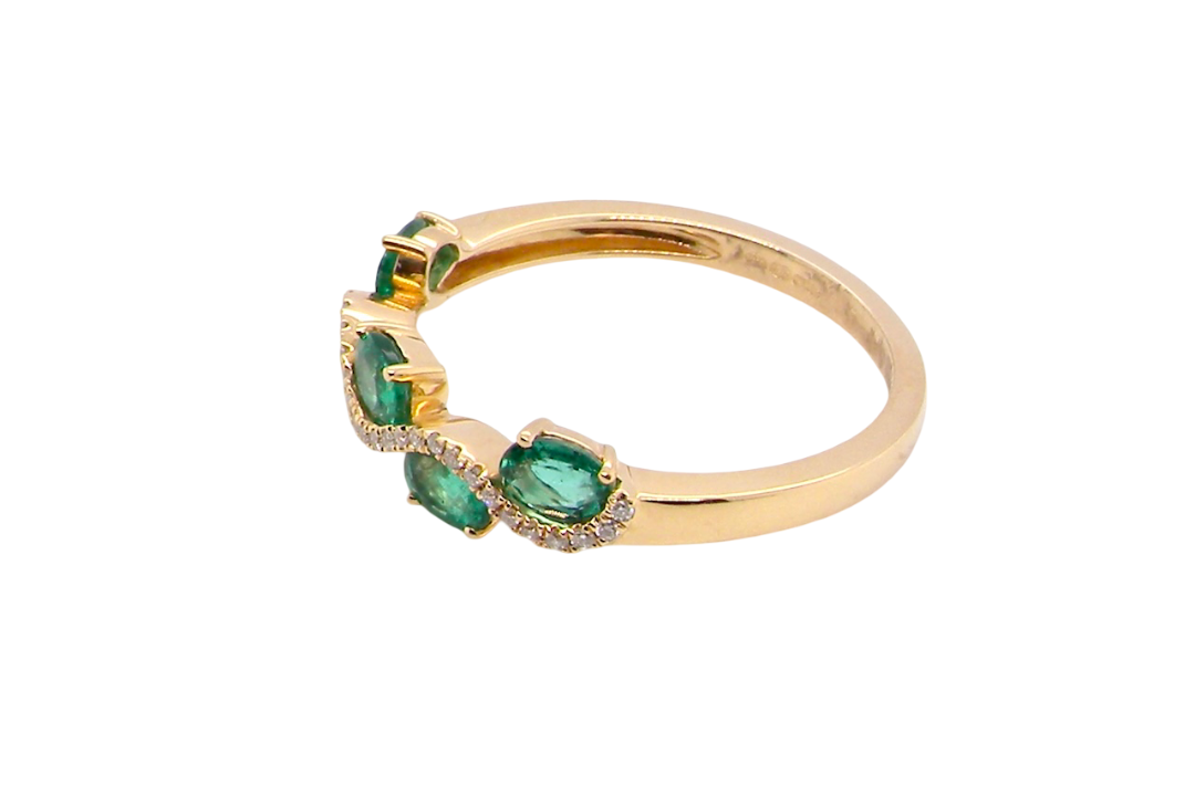 side A half hoop ring with a very attractive line of oval cut emeralds, each 4x3mm, a lovely deep grass green hue, and with very good clarity too.