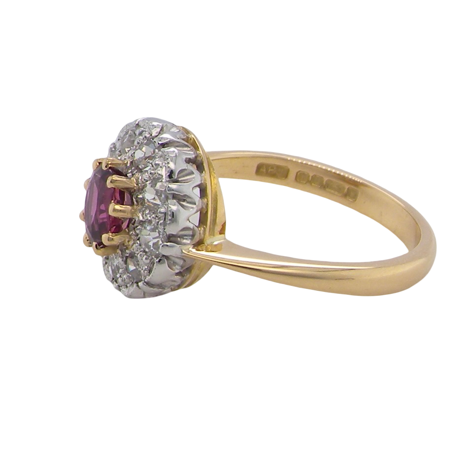 side A lovely daisy cluster ring that profiles to the centre a deep red ruby, 5mm (0.50 carats) yellow claw set.