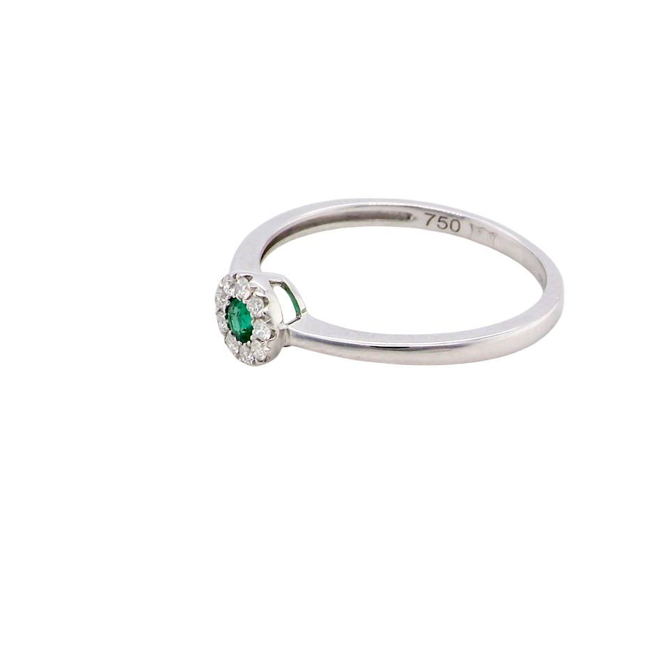 side A mini cluster fashioned in 18 carat white gold. The round emerald measures 2.7mm (0.05 carats) 
