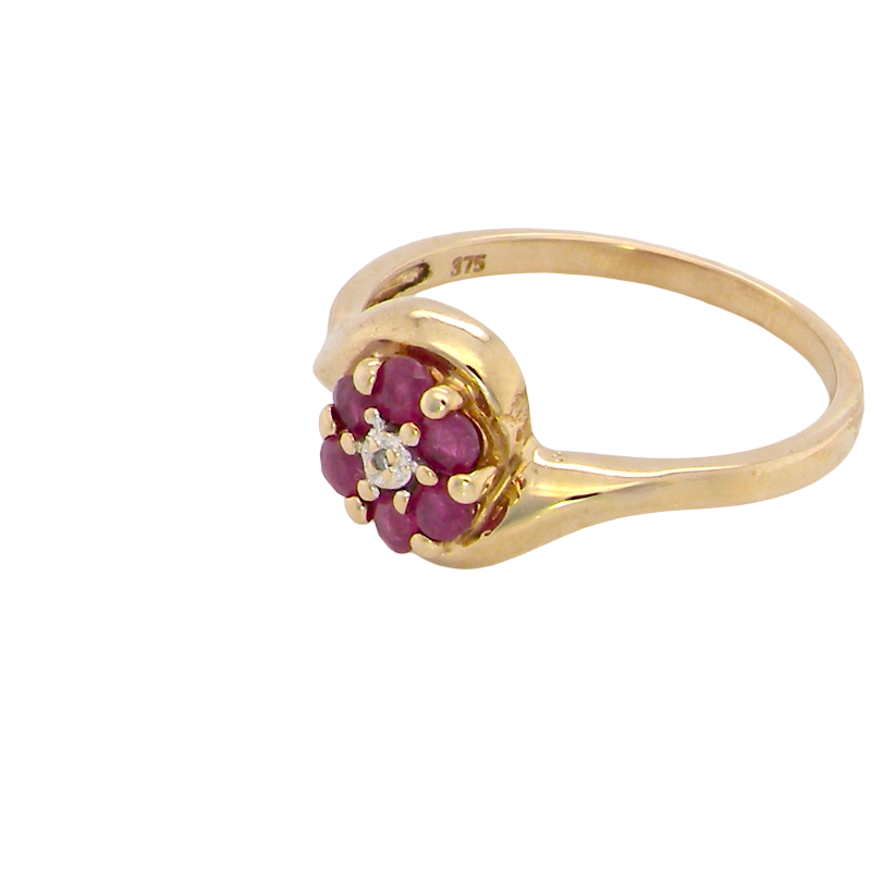 side A modern 9 carat gold cluster ring. At the centre a small diamond, this complimented by an outer halo of six 2.4mm rubies (each 0.05 carats)