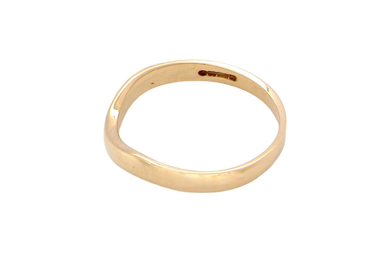 side A narrow 18 carat yellow gold wedding ring. This has a U shape which makes the placing of a cluster or even a solitaire engagement ring that much easier to place against as it will sit with the 'U'