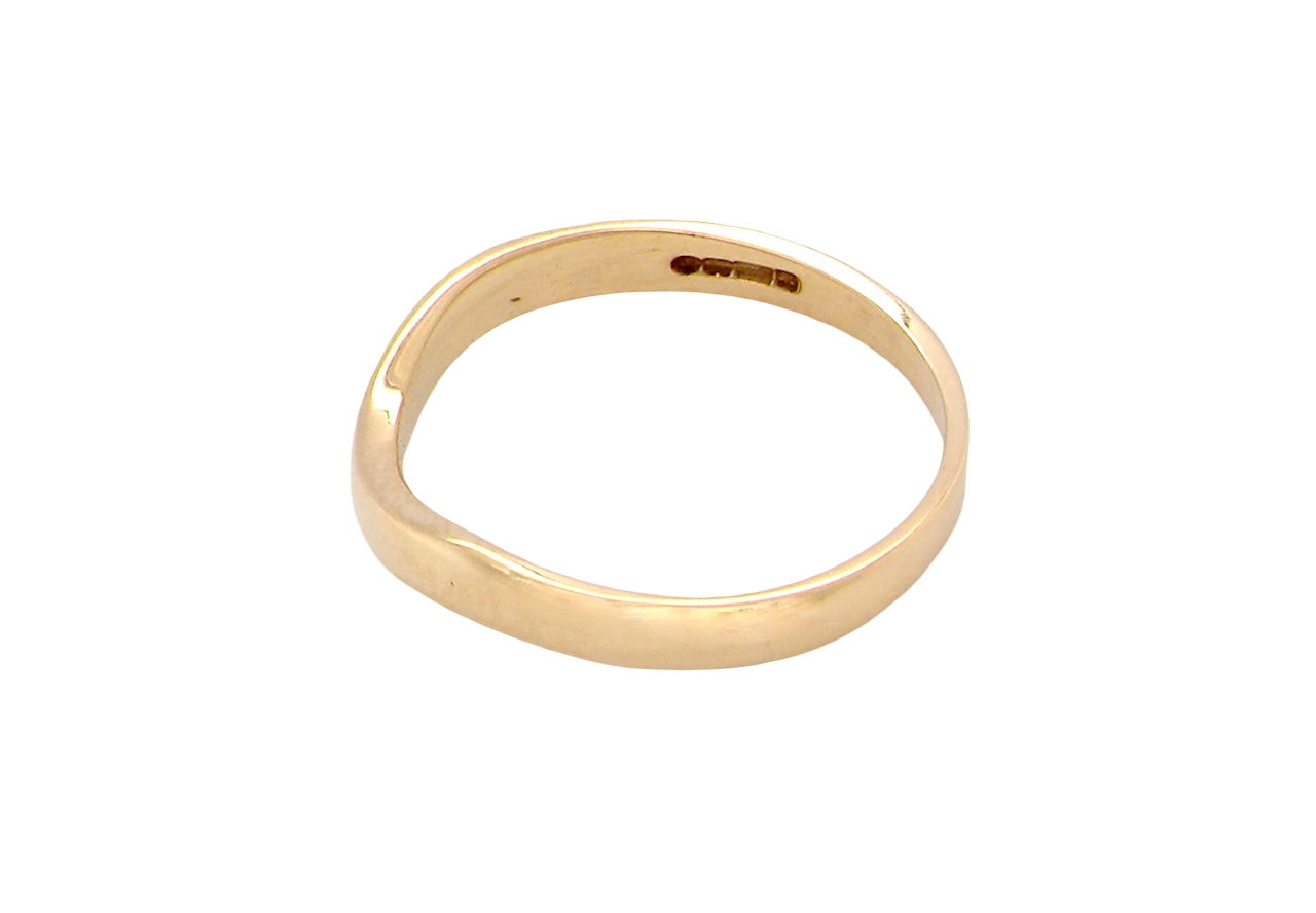 side A narrow 18 carat yellow gold wedding ring. This has a U shape which makes the placing of a cluster or even a solitaire engagement ring that much easier to place against as it will sit with the 'U'