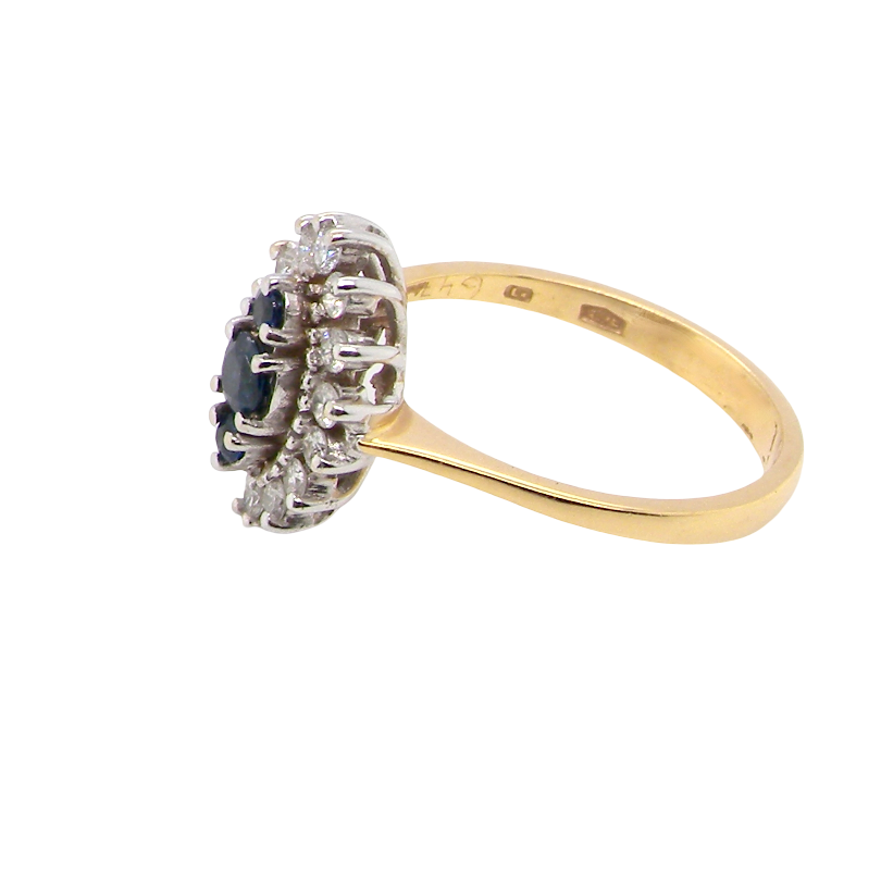 side A navette shaped cluster ring. The centre a line of three sapphires, 0ne x 3.5mm, 2 x 1.5mm.