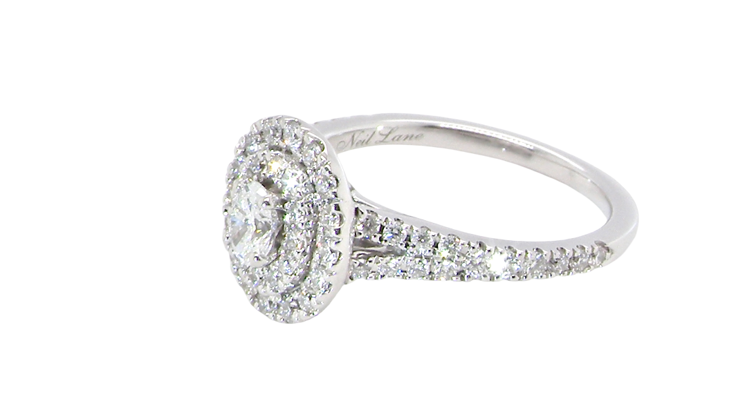 side A new diamond cluster ring* An oval diamond halo cluster ring. Set with brilliant cut white diamonds, colour H-k, clarity Si.