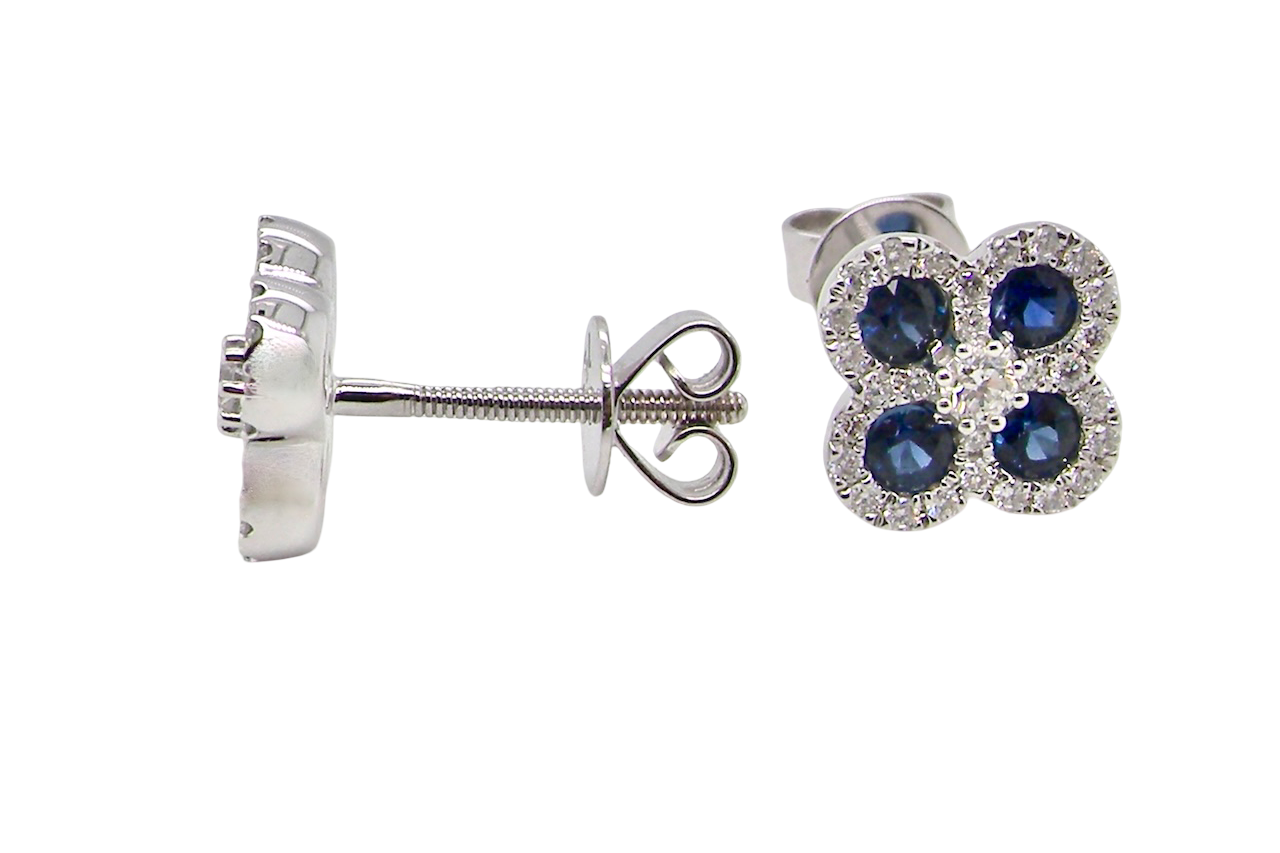 Silver earrings with blue gemstones on a white background