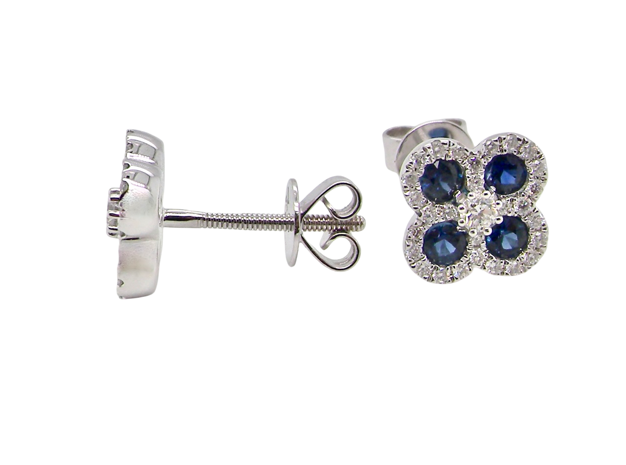 Silver earrings with blue gemstones on a white background
