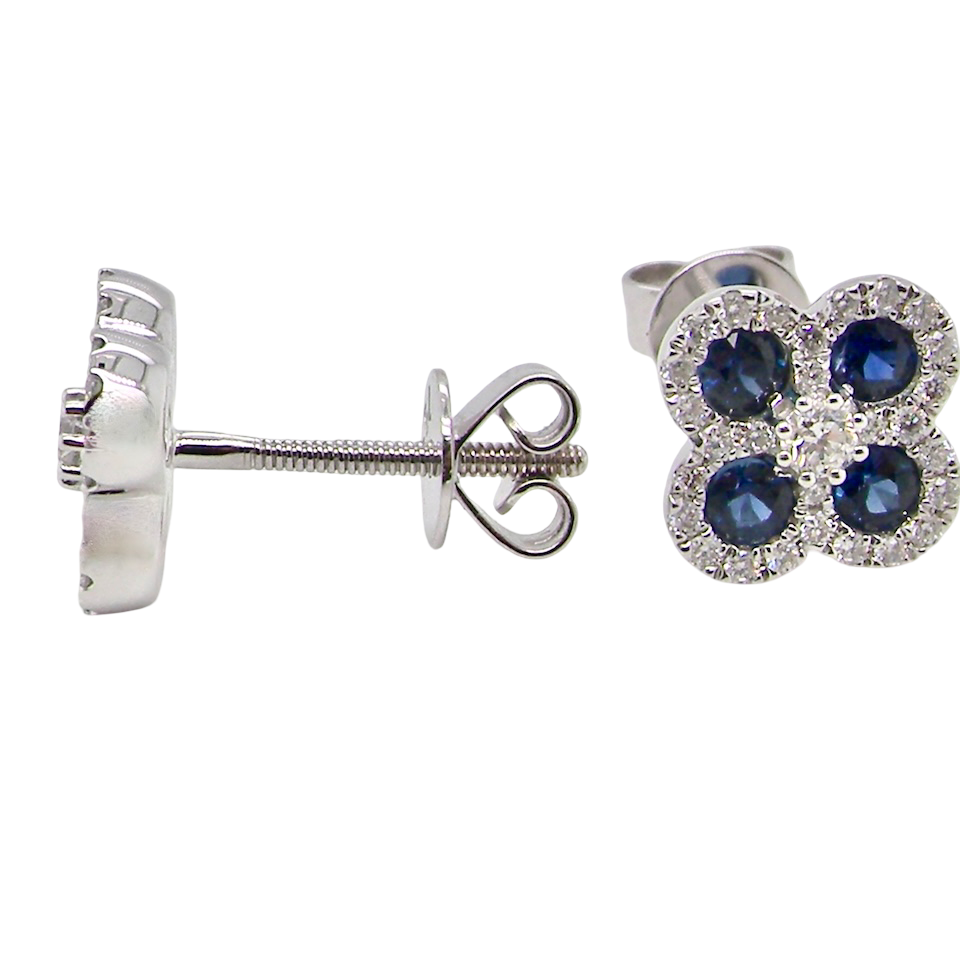 Silver earrings with blue gemstones on a white background