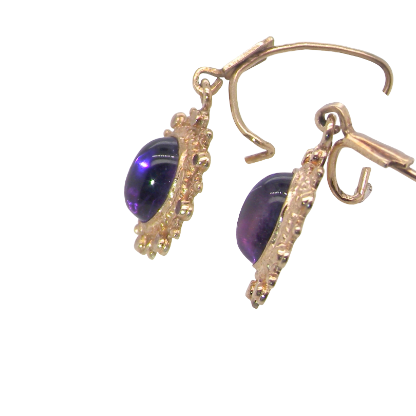 side A pair of drop earrings. Each set with a cabouchon cut amethyst 6x4mm and set with an antique look border.