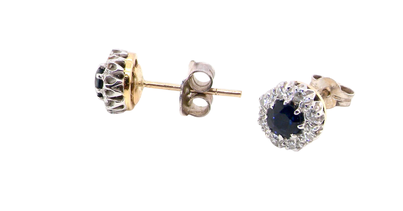 side A pair of stud cluster earrings. Each earring is set with a dark blue sapphire centre .
Measures 4mm, surrounded by an outer halo of eight 1.3mm diamonds