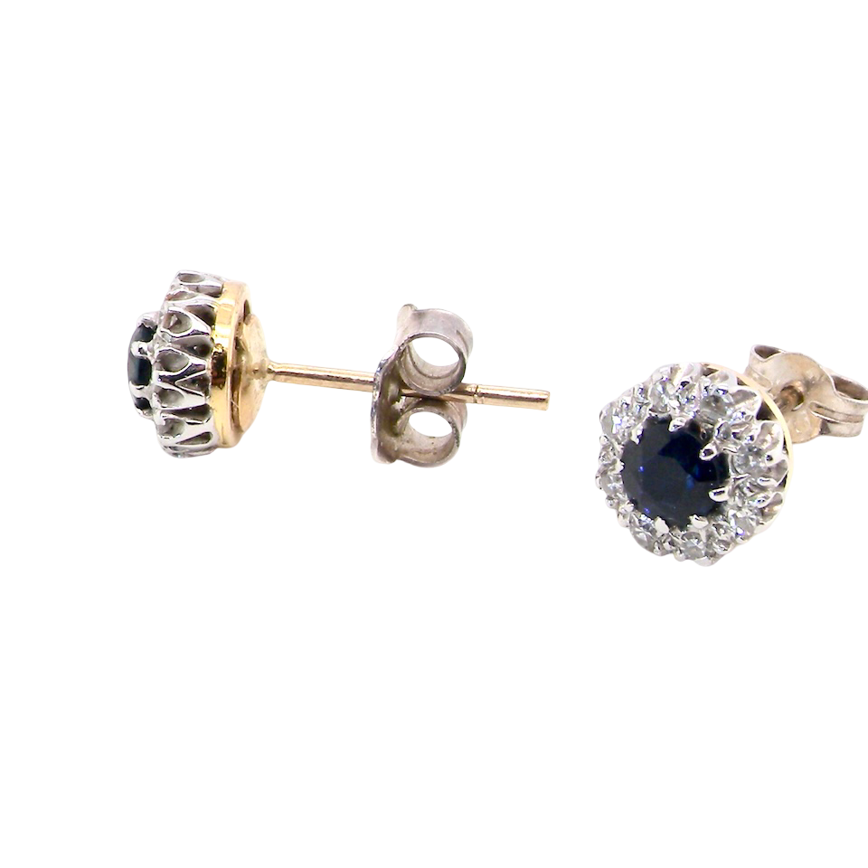 side A pair of stud cluster earrings. Each earring is set with a dark blue sapphire centre .
Measures 4mm, surrounded by an outer halo of eight 1.3mm diamonds