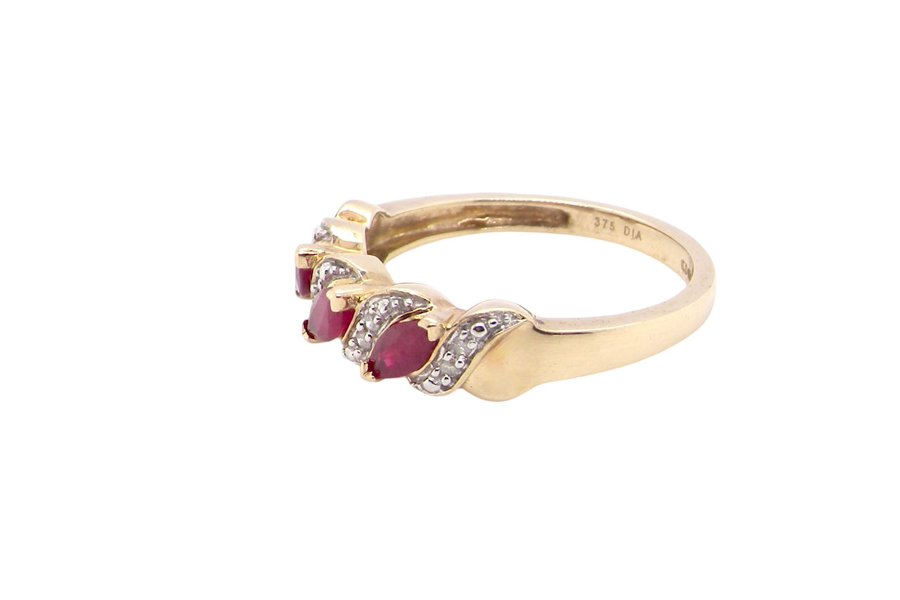 side A pretty 9 carat gold dress ring. The three rubies are marquise cut, 5x3mm each, and set at an angle .