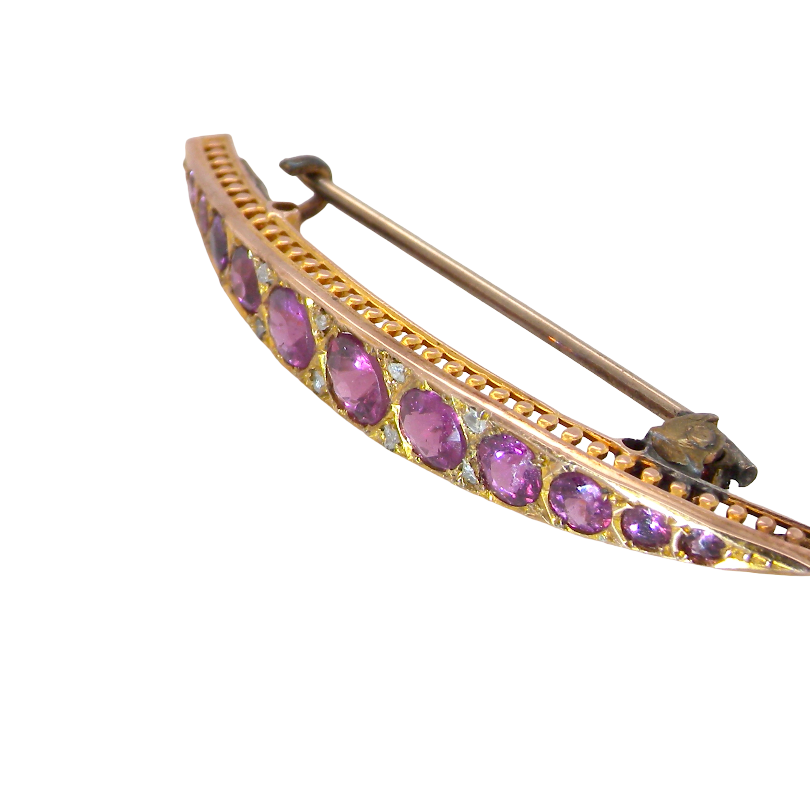 side A pretty Victorian crescent shaped brooch. The principal stones are almandine garnets