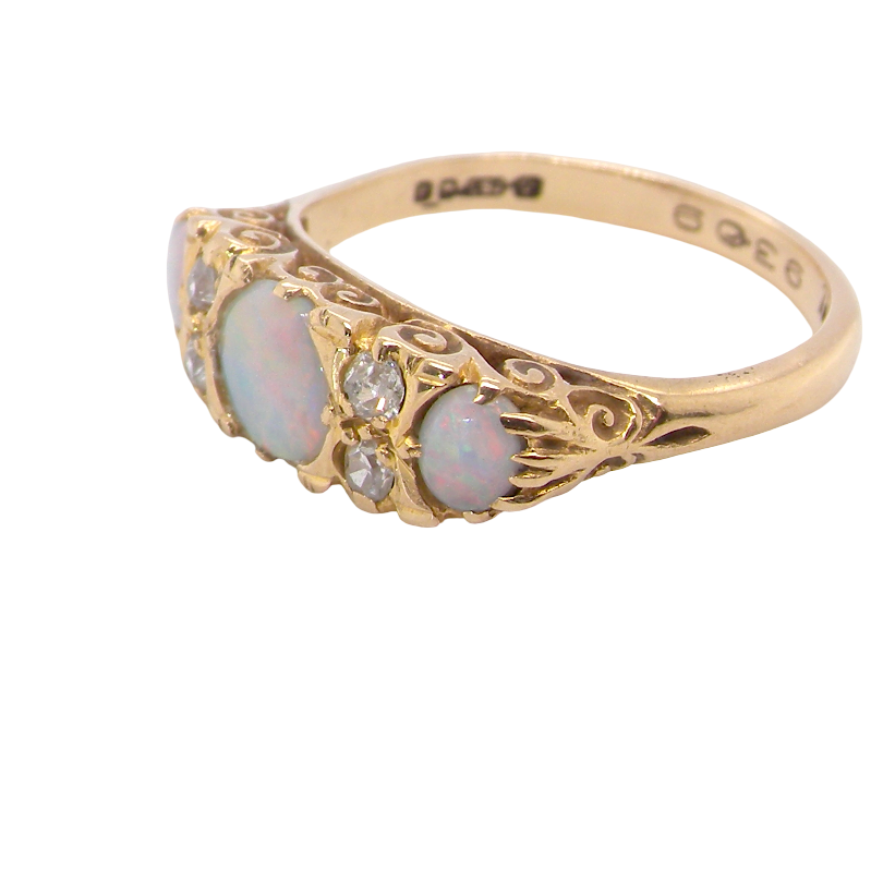side A pretty Victorian style ring. 18 carat gold. There are three opals, centre 6mm, each end 4x3mm. Good colour play