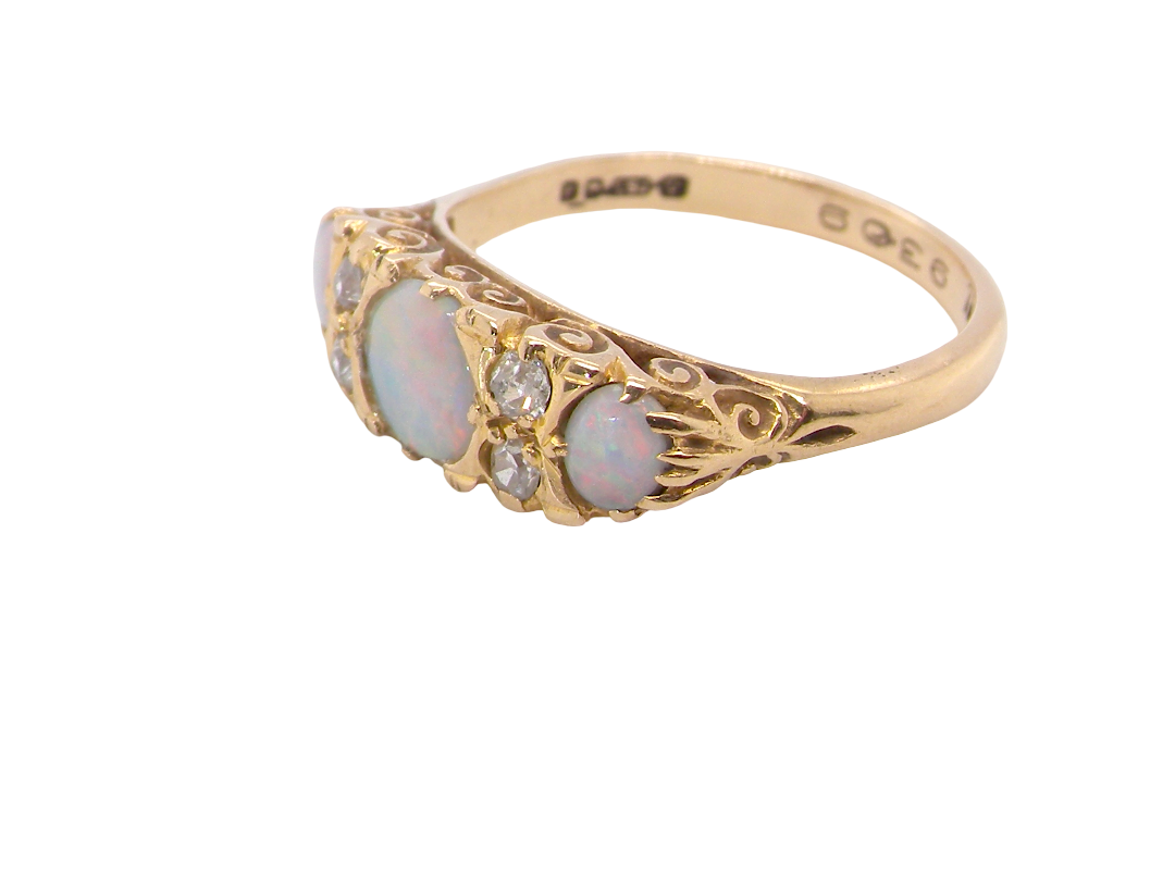 side A pretty Victorian style ring. 18 carat gold. There are three opals, centre 6mm, each end 4x3mm. Good colour play