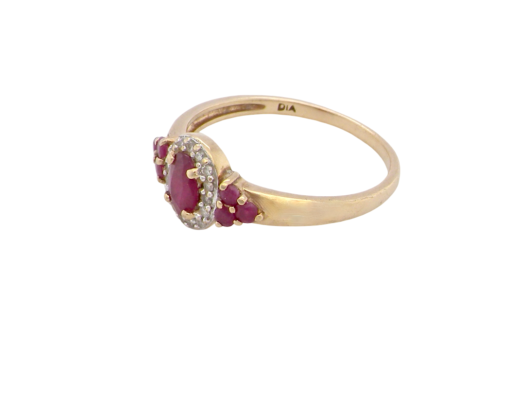 side A pretty cluster ring that features to the centre an oval cut ruby, 5x4mm, retained by four claws and an outer halo of sixteen small white diamonds, each 1.3mm (total estimated at 0.15 carats) 