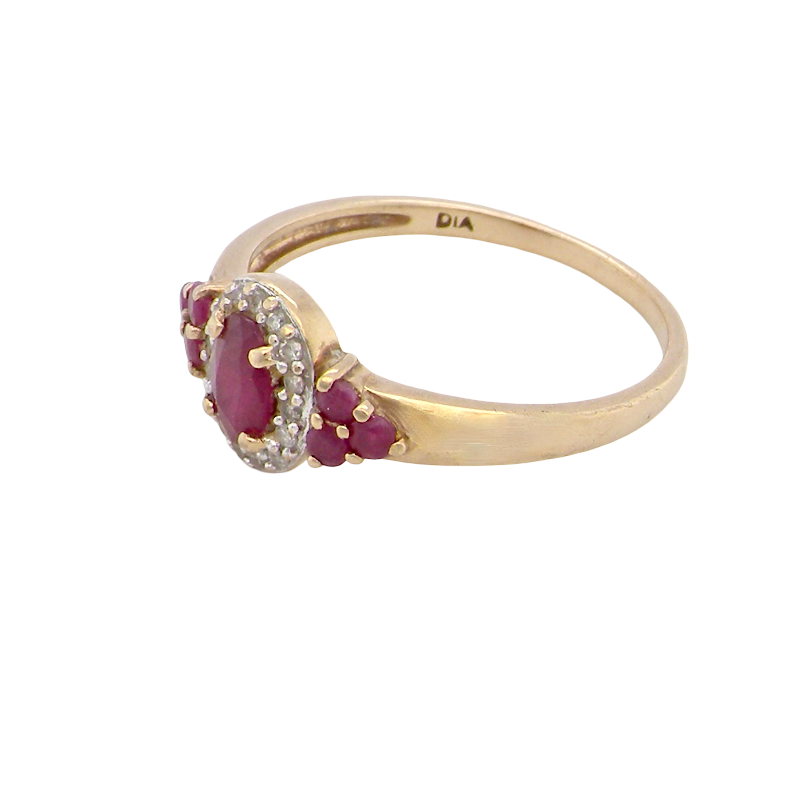 side A pretty cluster ring that features to the centre an oval cut ruby, 5x4mm, retained by four claws and an outer halo of sixteen small white diamonds, each 1.3mm (total estimated at 0.15 carats) 