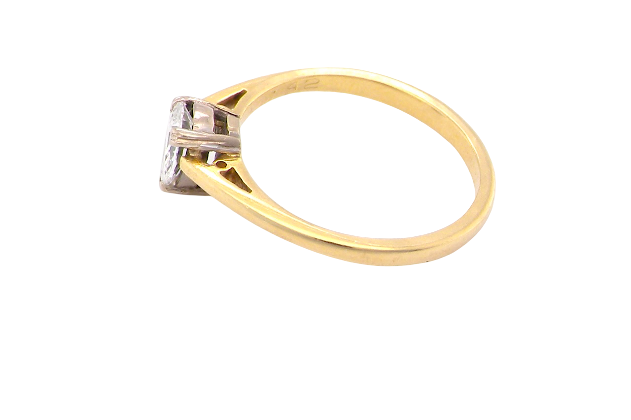 Gold ring with a diamond on a white background