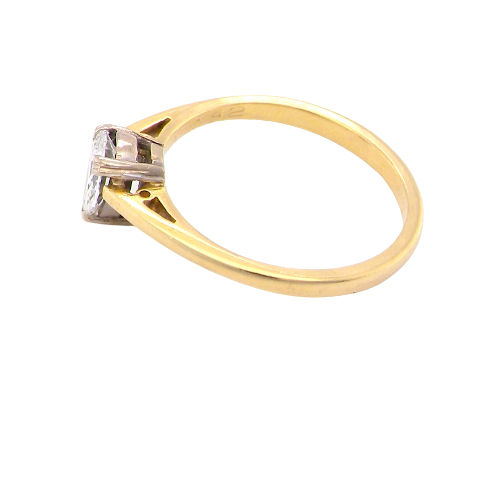 Gold ring with a diamond on a white background