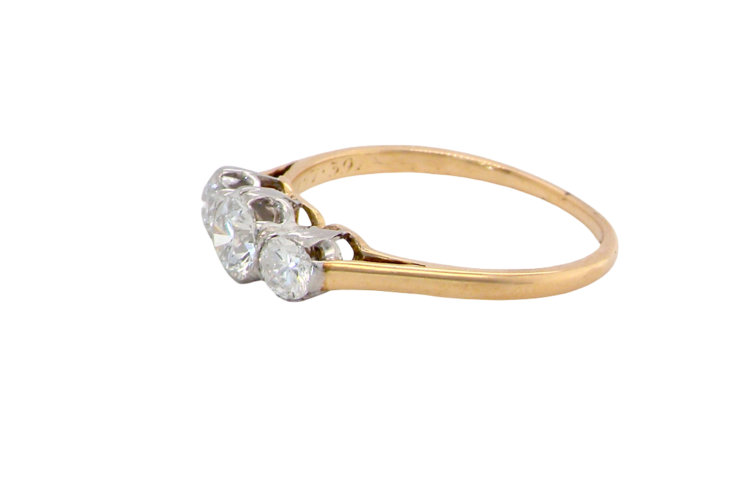 side A pretty three stone trilogy ring that features three brilliant cut white diamonds.
Centre diamond, 5mm (est 0.50 carats) each side a 4mm diamond (est 0.25 carats). Colour G-h, clarity Si. Platinum rim style setting, head measures 12.7x5.3mm, depth 5.3mm, weight 2.4grams.