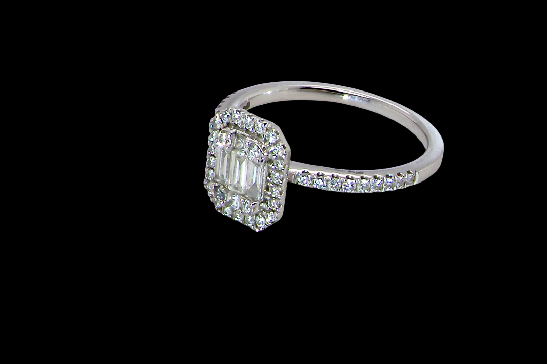 side A rectangular diamond cluster ring. Centre portion is set with three baguette cut white diamonds 3x1.6mm and six mixed cut diamonds 2mm each.
Surrounded by a halo of twenty two small round diamonds