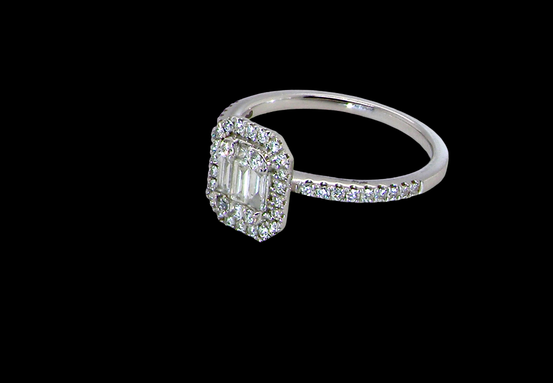 side A rectangular diamond cluster ring. Centre portion is set with three baguette cut white diamonds 3x1.6mm and six mixed cut diamonds 2mm each.
Surrounded by a halo of twenty two small round diamonds