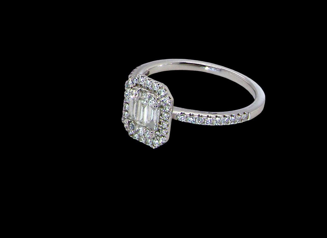 side A rectangular diamond cluster ring. Centre portion is set with three baguette cut white diamonds 3x1.6mm and six mixed cut diamonds 2mm each.
Surrounded by a halo of twenty two small round diamonds