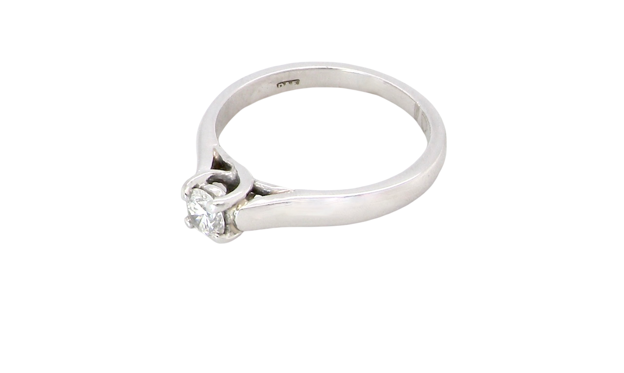 side A single stone solitaire diamond ring. The modern brilliant cut white diamond measures 3.9mm (0.22 carats est) Colour G-h, clarity VS.